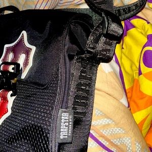 Trapstar brand new side bag with the red and black shade on the logo